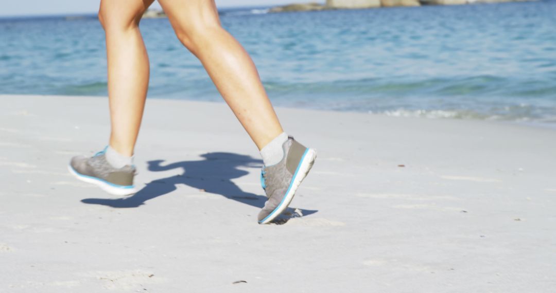 Woman Running on Sandy Beach in Athletic Shoes - Free Images, Stock Photos and Pictures on Pikwizard.com