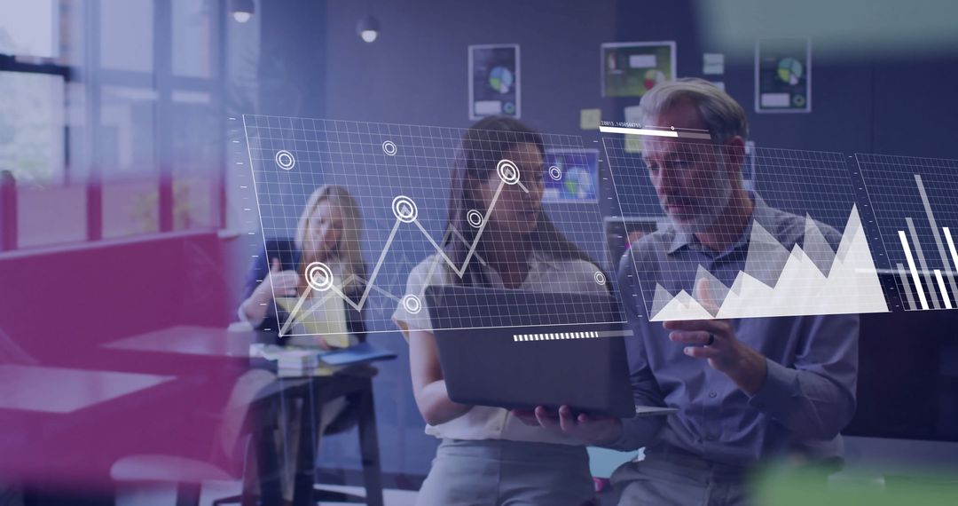 Diverse Business Team Analyzing Data with Graphs and Laptop Technology