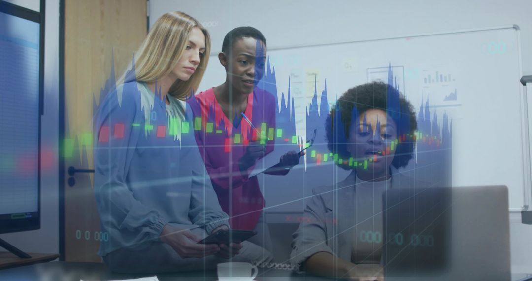 Diverse team analyzing financial charts on laptop during collaborative office meeting