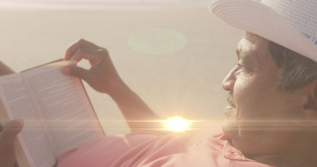 Relaxing Older Man Reading on Sunny Beach