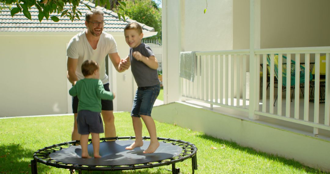 Father and Sons Enjoy Backyard Trampoline Fun - Free Images, Stock Photos and Pictures on Pikwizard.com