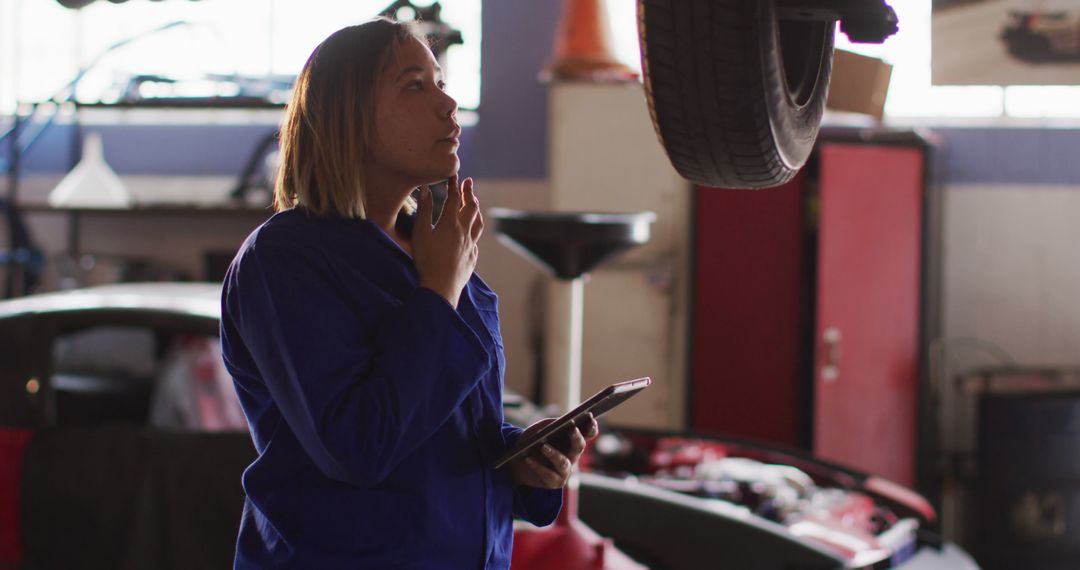 Female Mechanic Analyzing Car Issues with Digital Tablet in Workshop - Free Images, Stock Photos and Pictures on Pikwizard.com