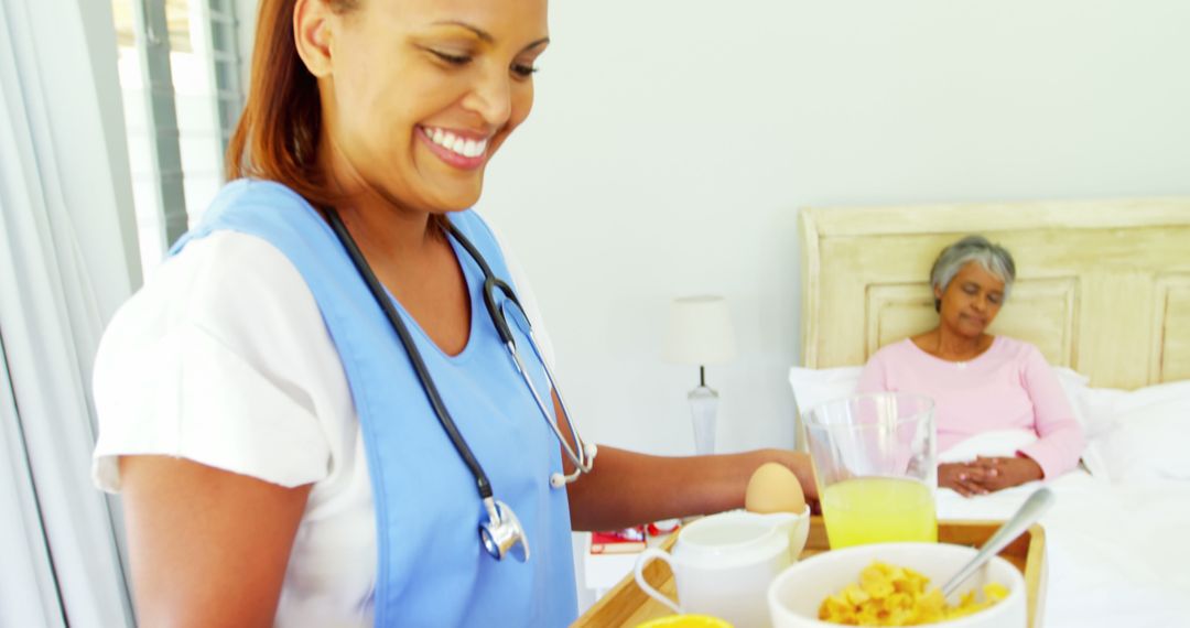 Smiling Nurse Serving Breakfast to Elderly Woman in Bed - Free Images, Stock Photos and Pictures on Pikwizard.com