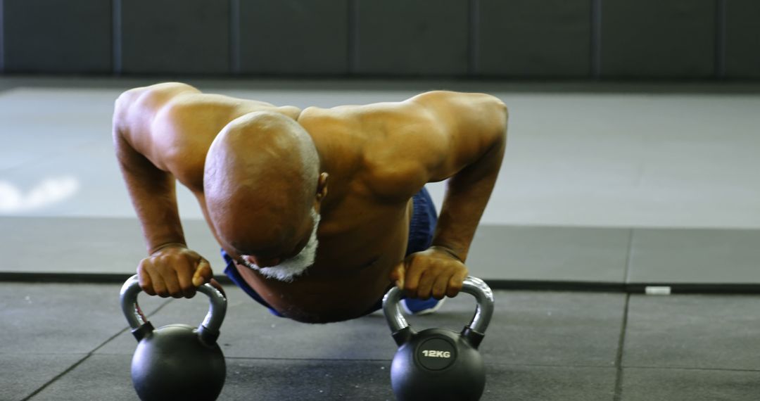 Senior African American Man Performing Push-Up with Kettlebells - Free Images, Stock Photos and Pictures on Pikwizard.com