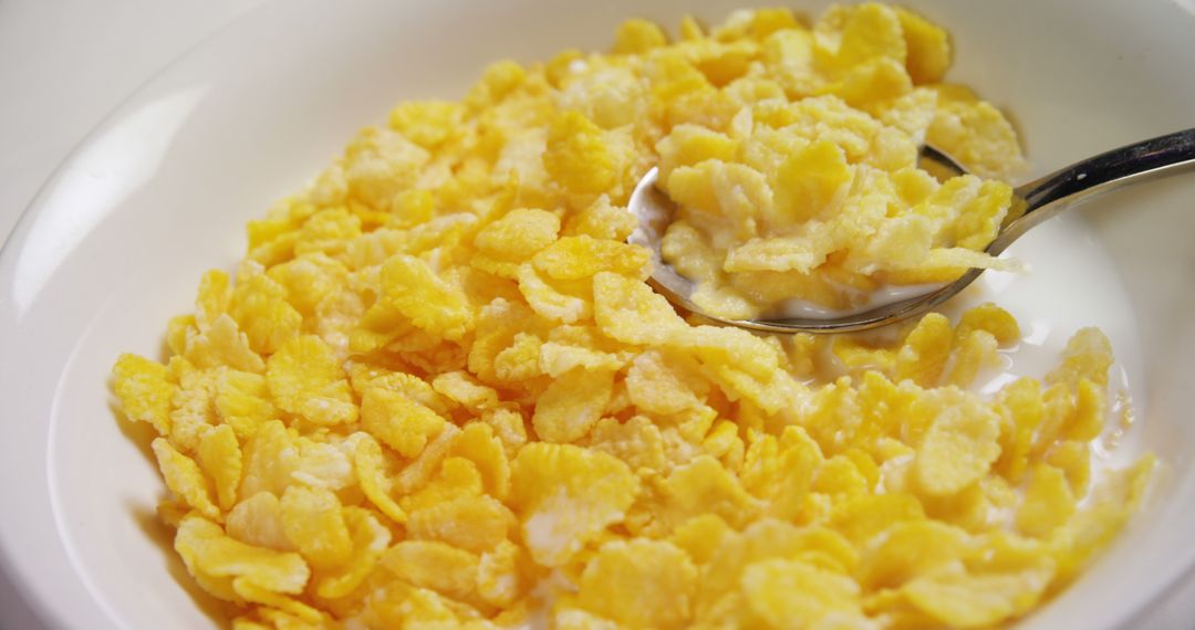 Bowl of Cornflakes with Milk and Spoon Close-Up - Free Images, Stock Photos and Pictures on Pikwizard.com