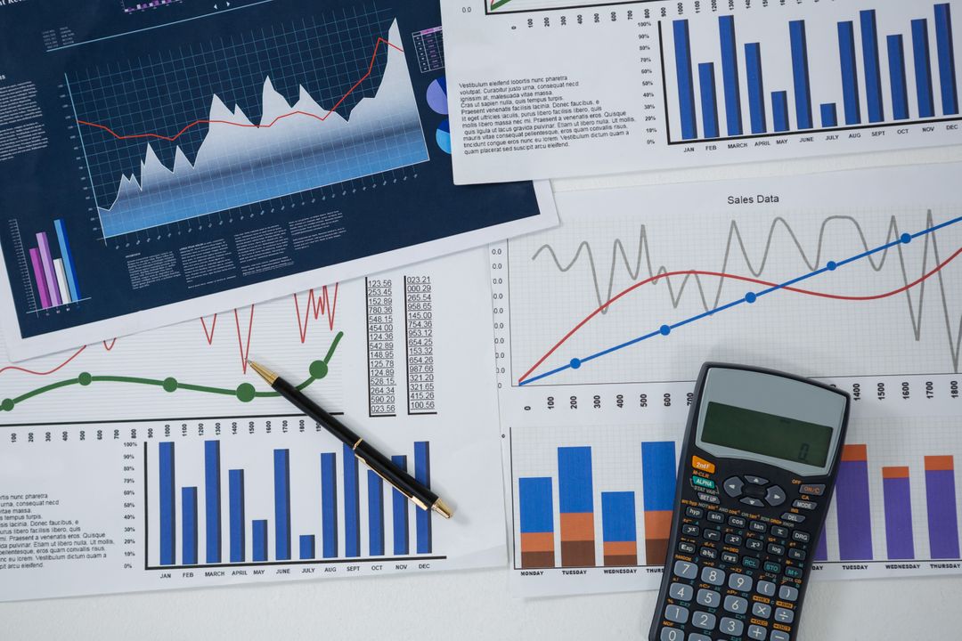 Financial Analysis with Graphs, Pen, and Calculator - Free Images, Stock Photos and Pictures on Pikwizard.com