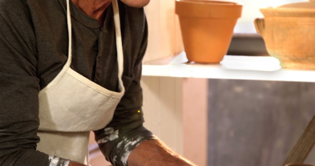 Close-up of a Potter Wearing Apron Creating Ceramic Pot - Free Images, Stock Photos and Pictures on Pikwizard.com