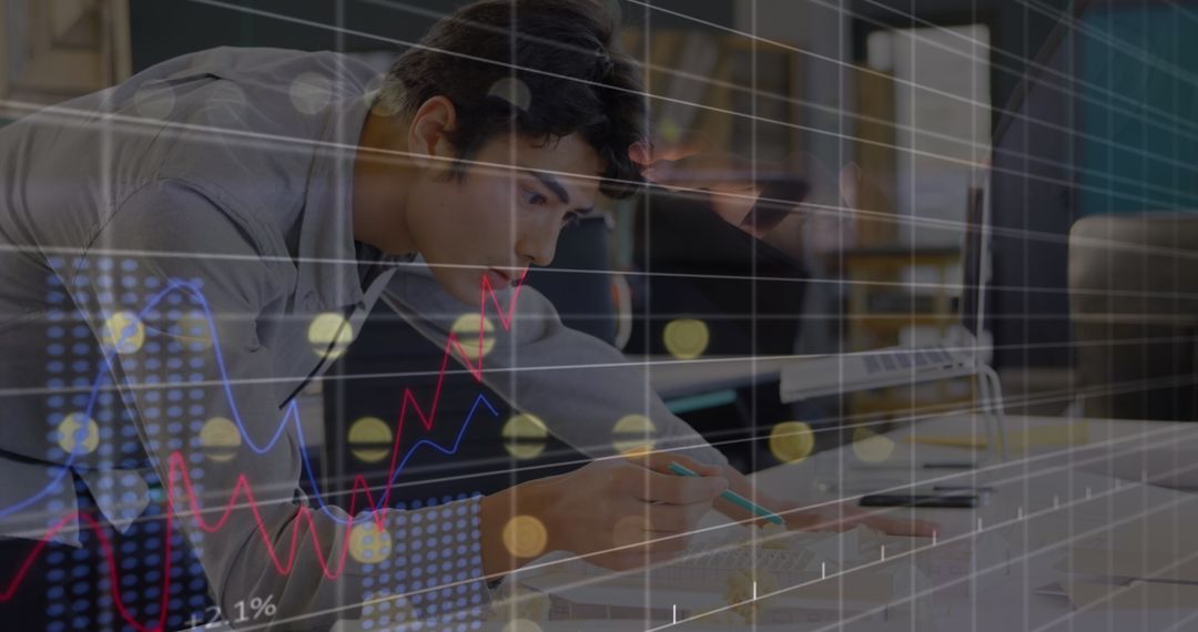 Young Businessman Analyzing Financial Data at Office Desk