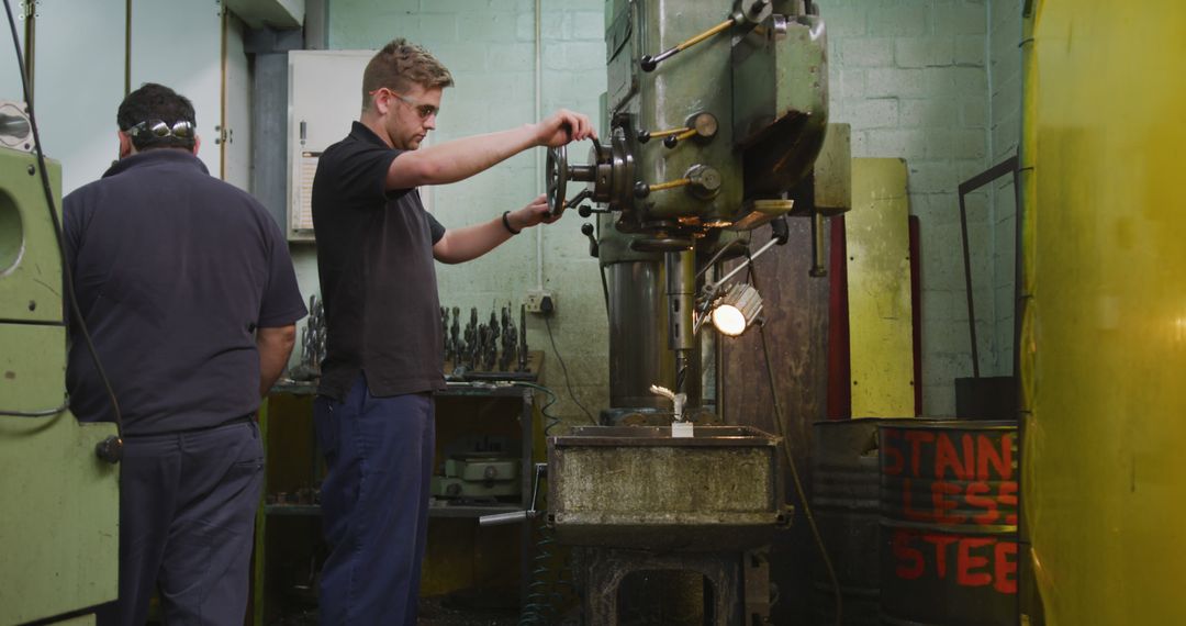 Engineers Working in Machine Shop Using Drill Press - Free Images, Stock Photos and Pictures on Pikwizard.com