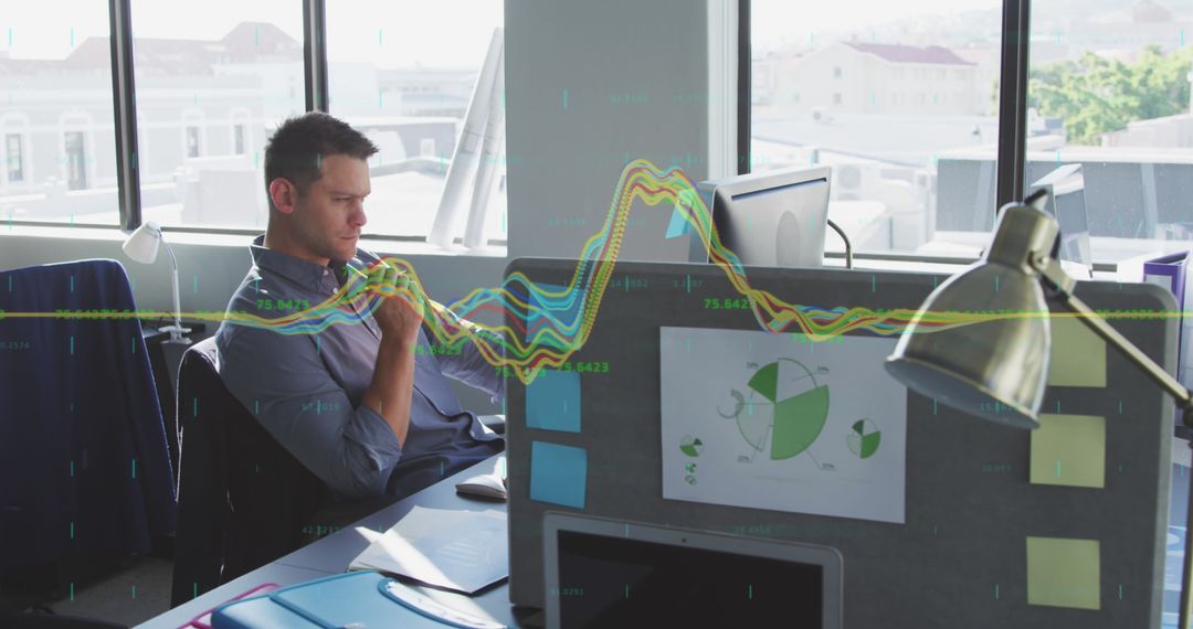 Businessman Analyzing Complex Financial Data in Modern Office