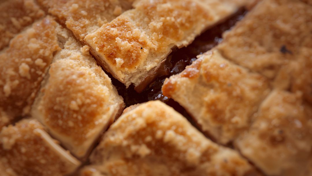 Golden Lattice Fruit Pie Slice Revealing Glossy Jam and Sugar-Crust Texture