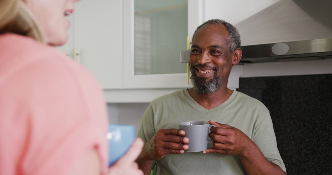 Joyful Man Having Conversation in Modern Kitchen - Free Images, Stock Photos and Pictures on Pikwizard.com