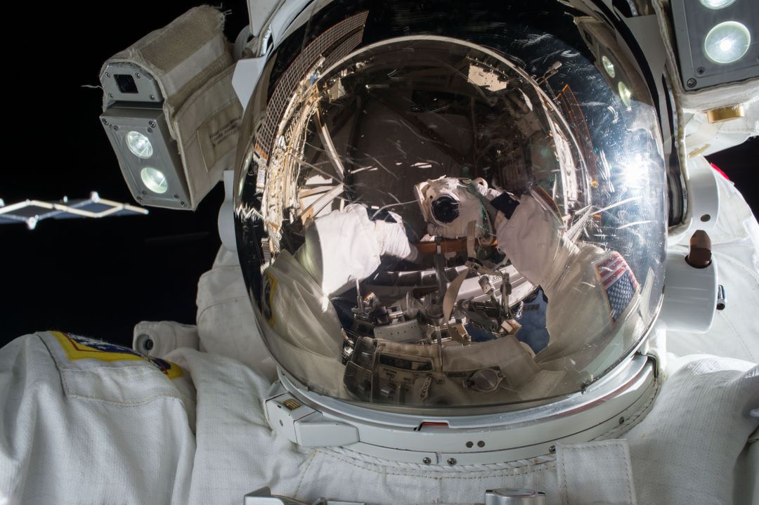 Astronaut Performing Spacewalk Reflection in Helmet Visor - Free Images, Stock Photos and Pictures on Pikwizard.com