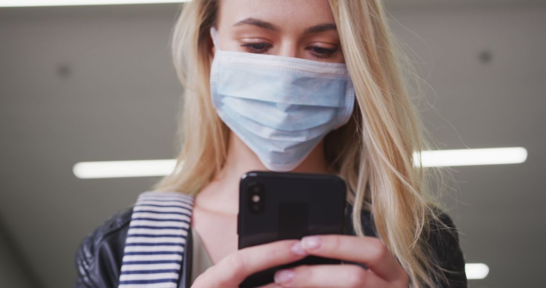 Young Woman in Protective Face Mask Using Smartphone - Free Images, Stock Photos and Pictures on Pikwizard.com