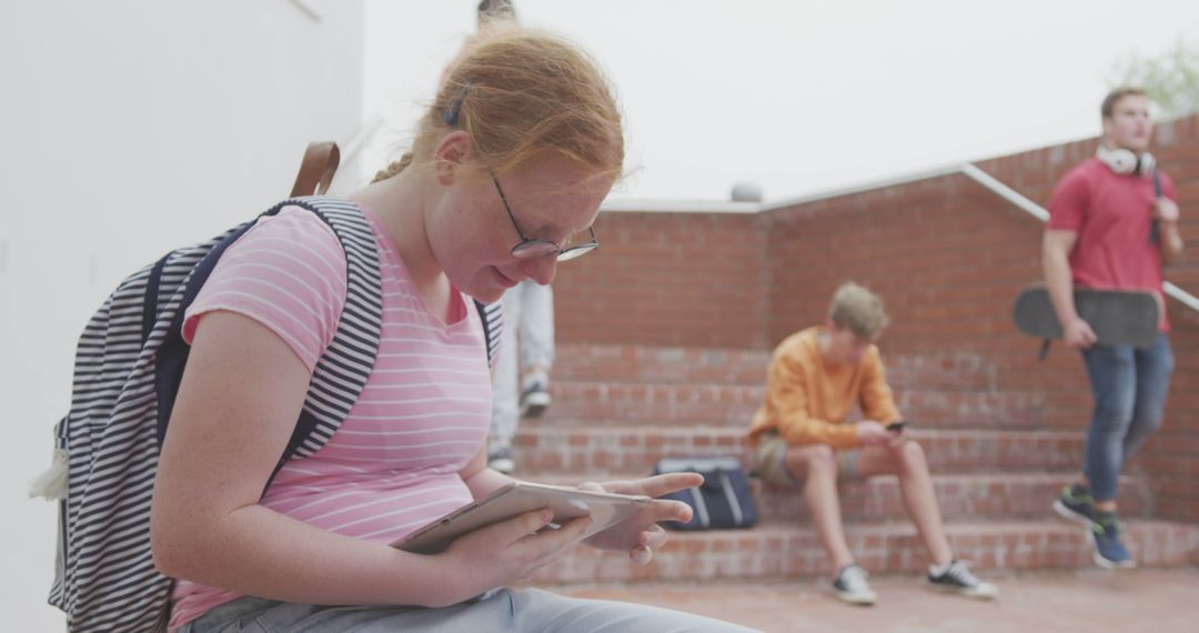 Teenage Students Using Digital Devices Outdoors - Free Images, Stock Photos and Pictures on Pikwizard.com