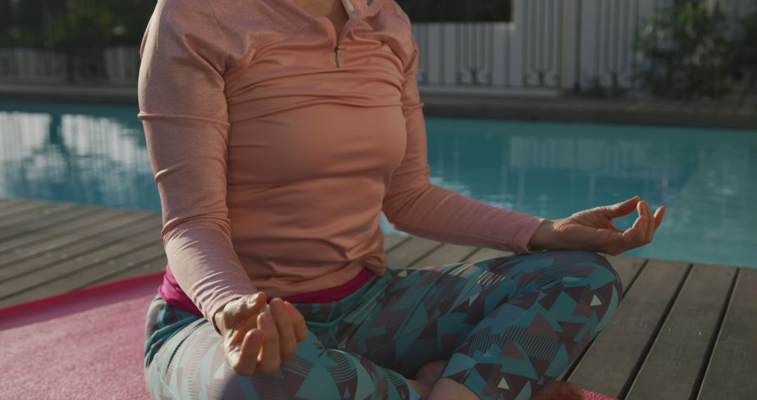 Senior Woman Meditating by Pool in Sunlit Garden - Free Images, Stock Photos and Pictures on Pikwizard.com