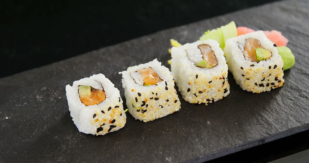 Close-Up of Delicious Sushi Rolls on Black Slate Board - Free Images, Stock Photos and Pictures on Pikwizard.com