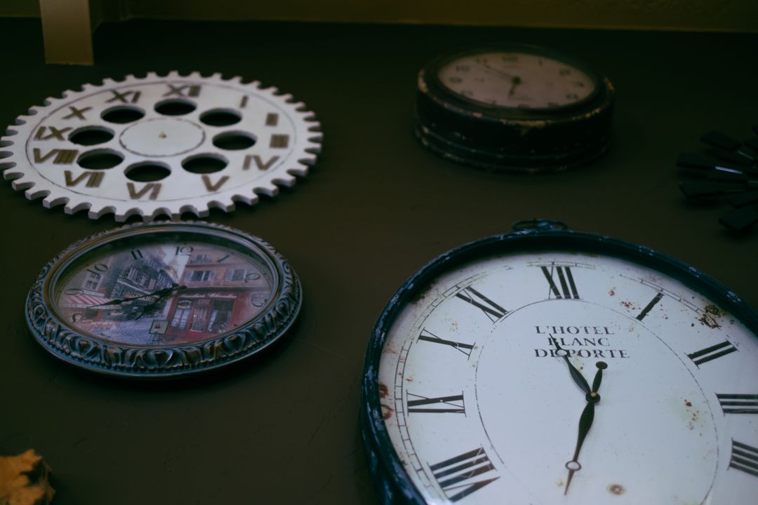Vintage Wall Clocks with Roman Numerals Displayed on Rusty Background - Free Images, Stock Photos and Pictures on Pikwizard.com