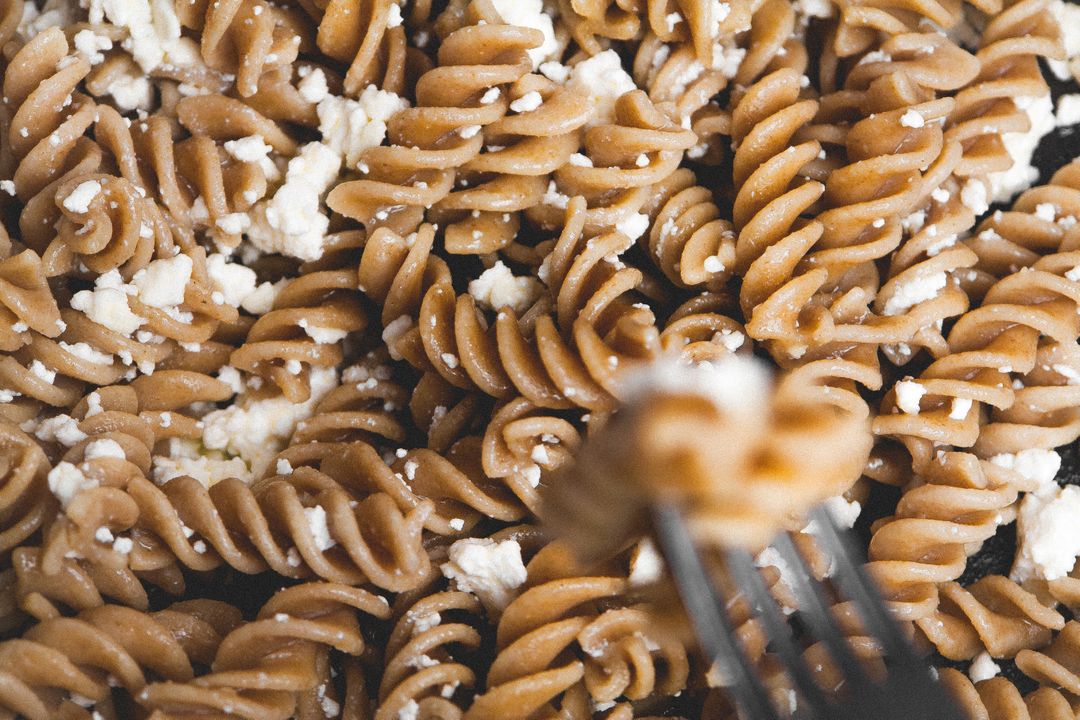 Whole Wheat Fusilli Pasta with Crumbled Feta Cheese Close-Up - Free Images, Stock Photos and Pictures on Pikwizard.com