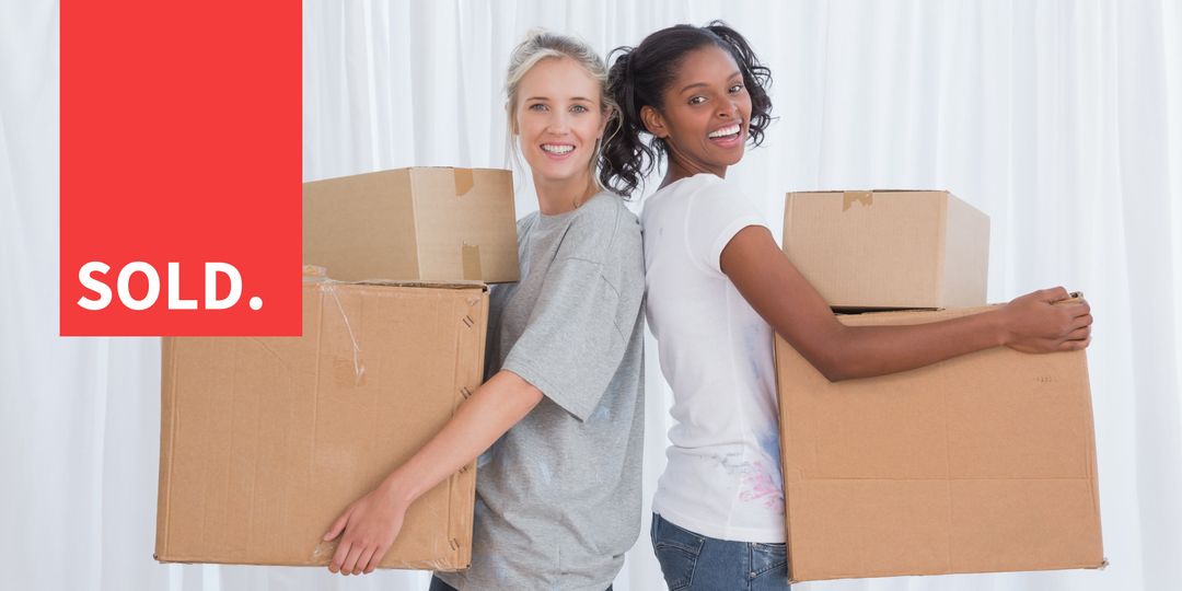 Smiling Women Holding Moving Boxes Celebrating Home Purchase - Download Free Stock Templates Pikwizard.com