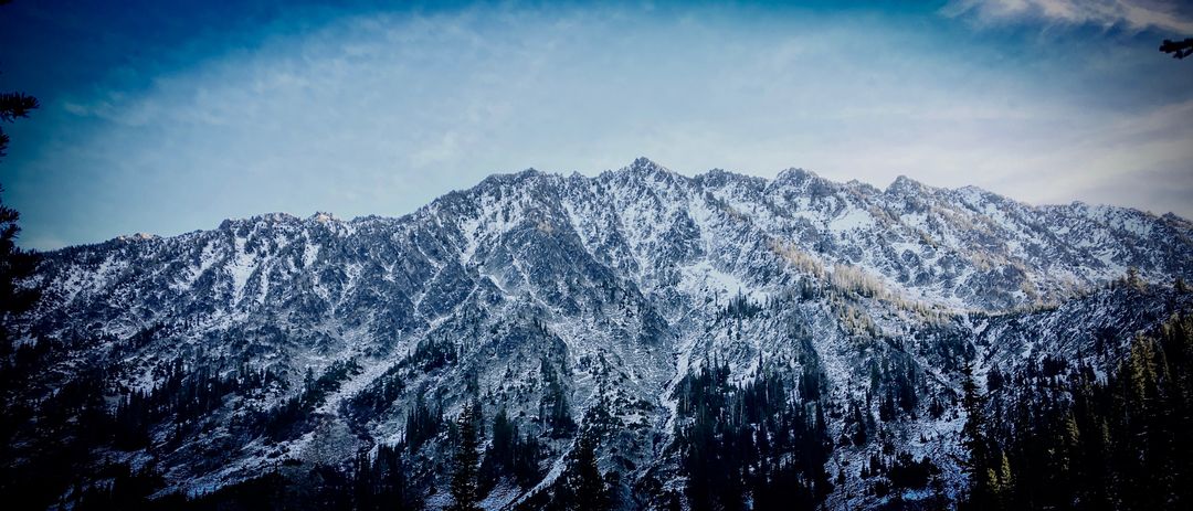 Snow-Covered Mountain Ridge on a Clear Blue Sky