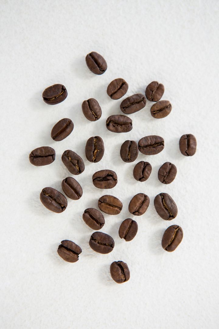 Top View of Roasted Coffee Beans on White Background - Free Images, Stock Photos and Pictures on Pikwizard.com