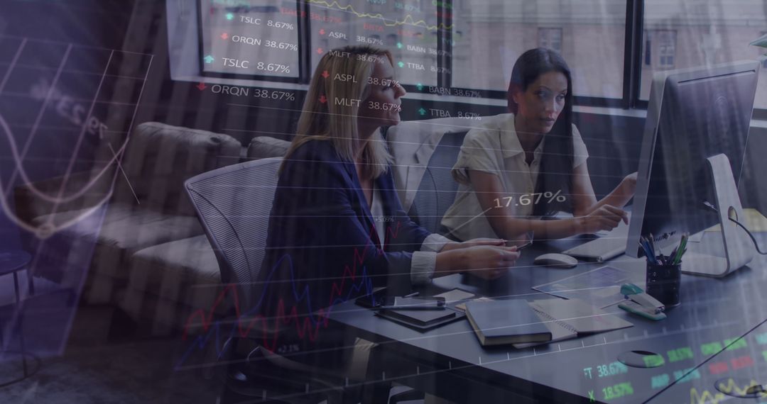 Two Businesswomen Analyzing Statistical Data in Modern Office