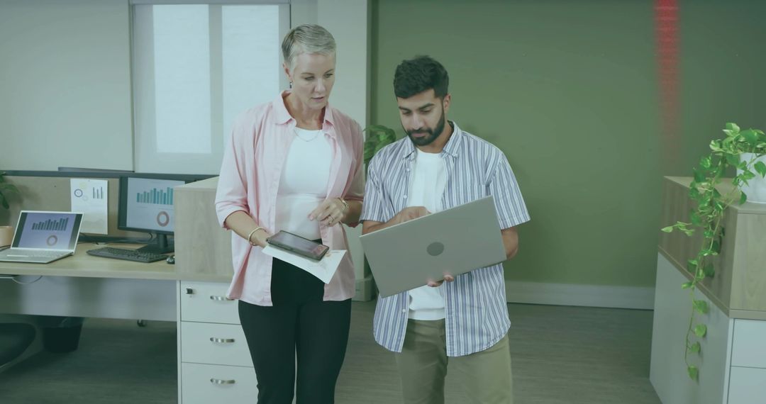 Office Colleagues Collaborating on Work Project with Laptop and Tablet