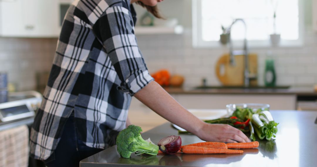 Woman Preparing Fresh Vegetables in Modern Kitchen Setting - Free Images, Stock Photos and Pictures on Pikwizard.com