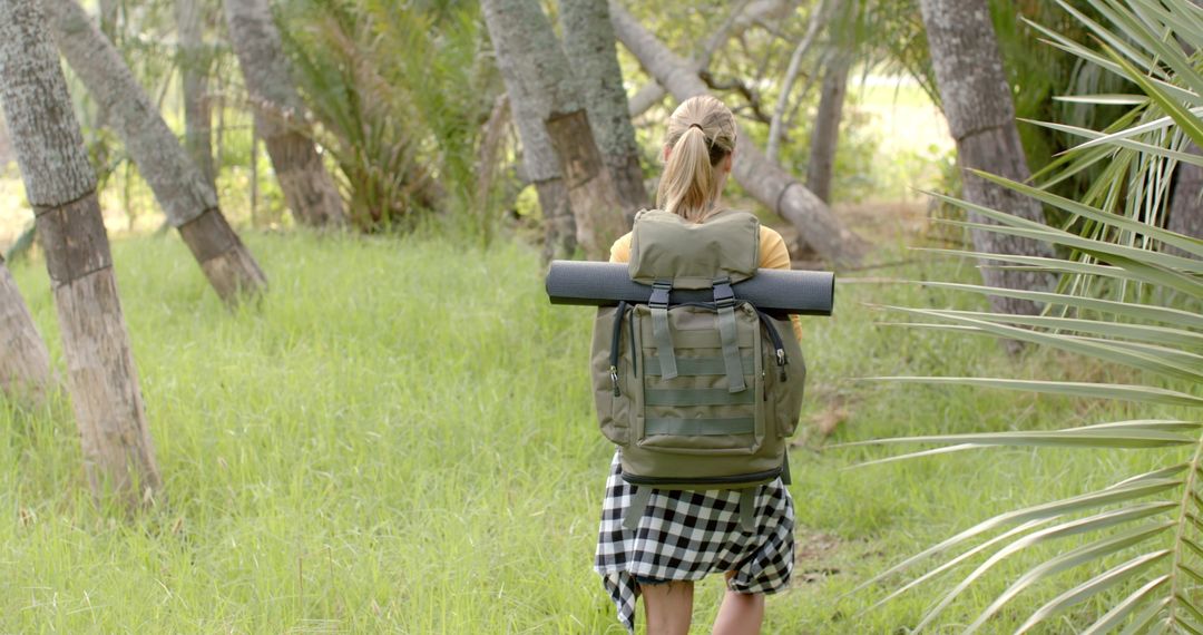 Woman Exploring Forest in Plaid Skirt and Backpack in Slow Motion