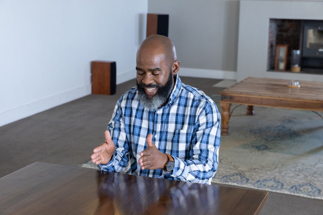 Senior African American Man Engaging in Conversation at Rustic Table