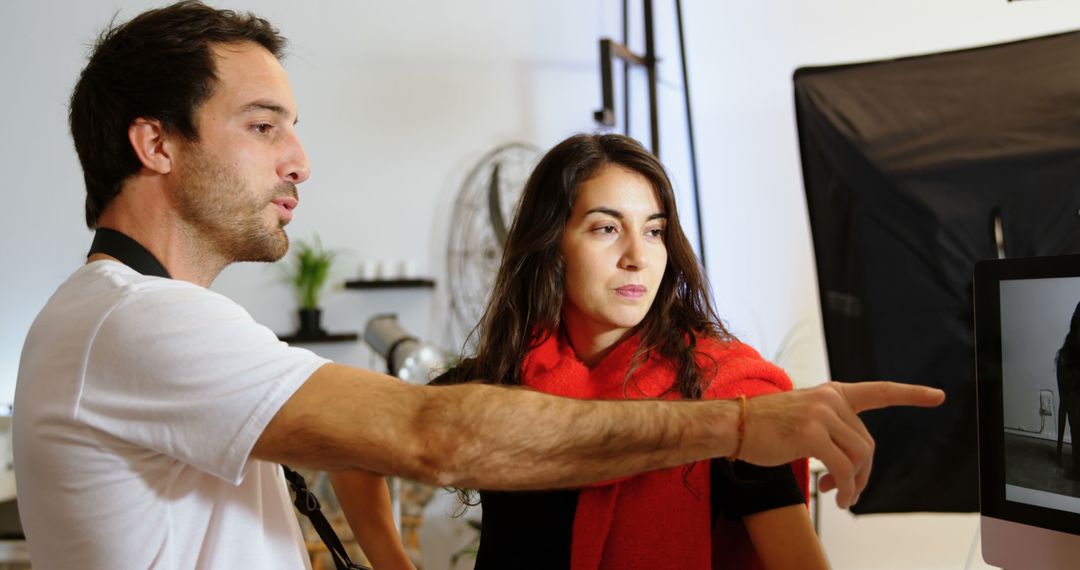 Creative Professionals Collaborating on Digital Project in Office