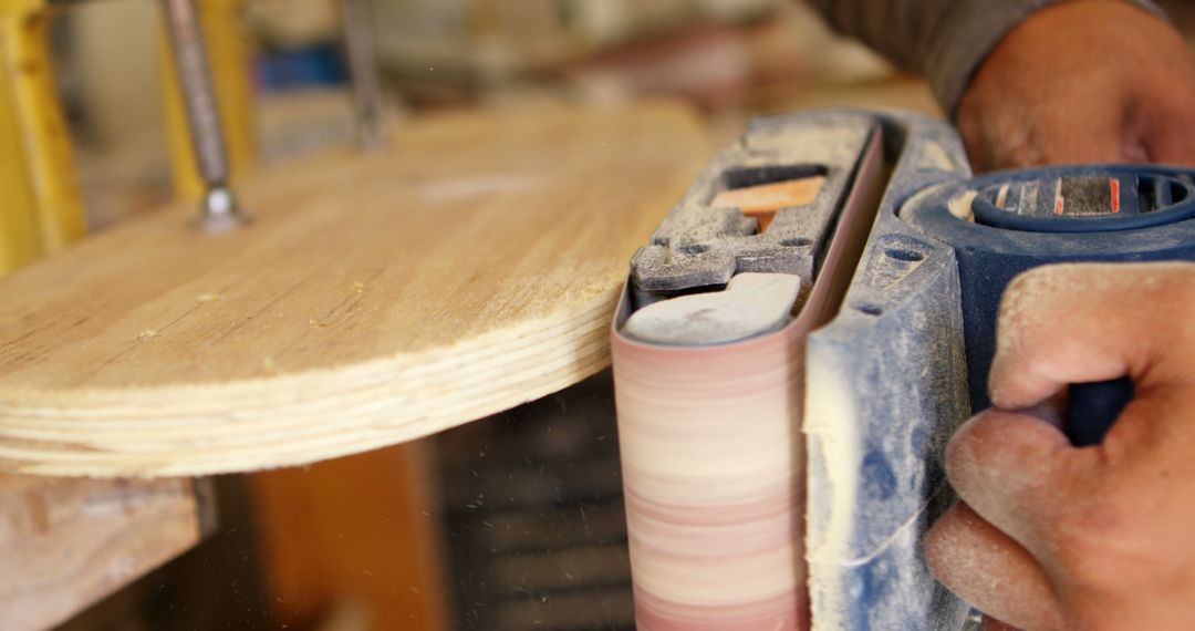 Close-up of Carpenter Polishing Wood with Electric Sander - Free Images, Stock Photos and Pictures on Pikwizard.com