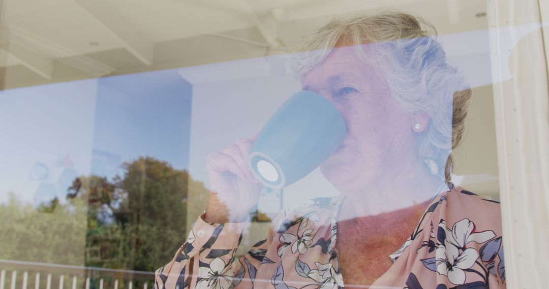 Senior Woman Drinking Coffee at Home Through Window - Free Images, Stock Photos and Pictures on Pikwizard.com