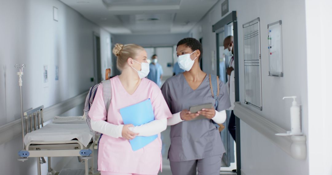 Nurses Collaborating in Hospital Hallway - Free Images, Stock Photos and Pictures on Pikwizard.com