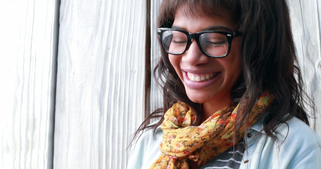 Joyful Woman Wearing Glasses and Floral Scarf Standing Outdoors - Free Images, Stock Photos and Pictures on Pikwizard.com