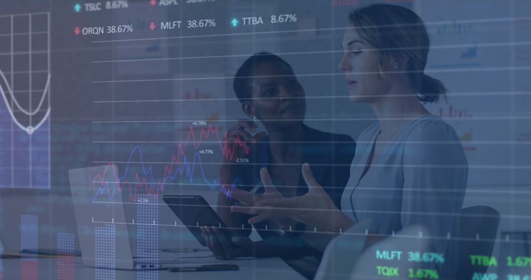 Businesswomen Analyzing Financial Data with Digital Overlay