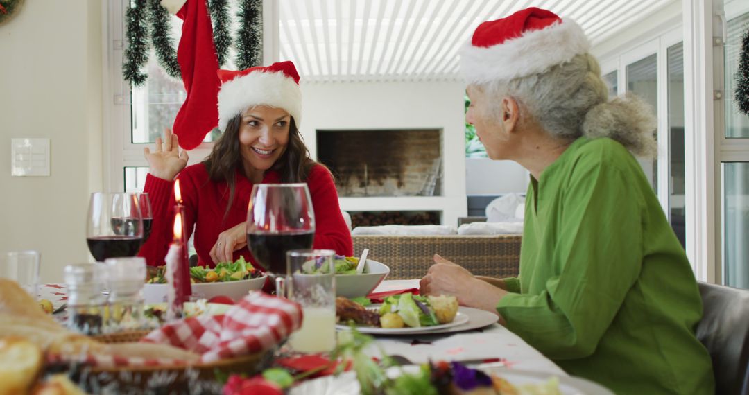 Festive Christmas Dinner Celebration with Family Santa Hats - Free Images, Stock Photos and Pictures on Pikwizard.com