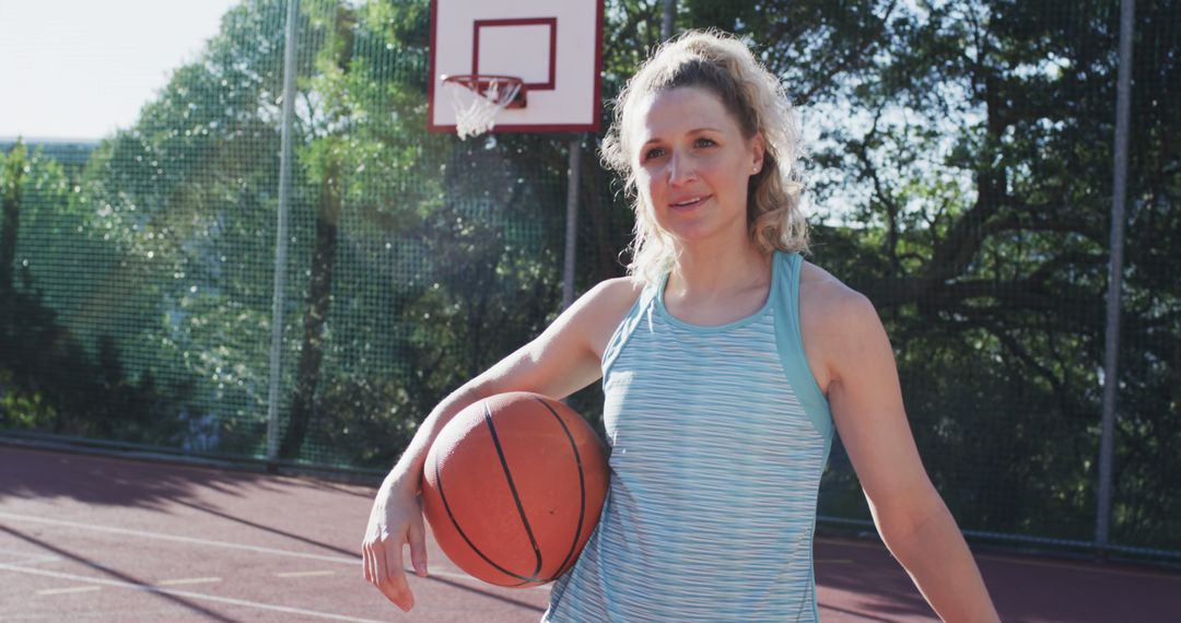 Woman Holding Basketball on Outdoor Court at Sunset - Free Images, Stock Photos and Pictures on Pikwizard.com