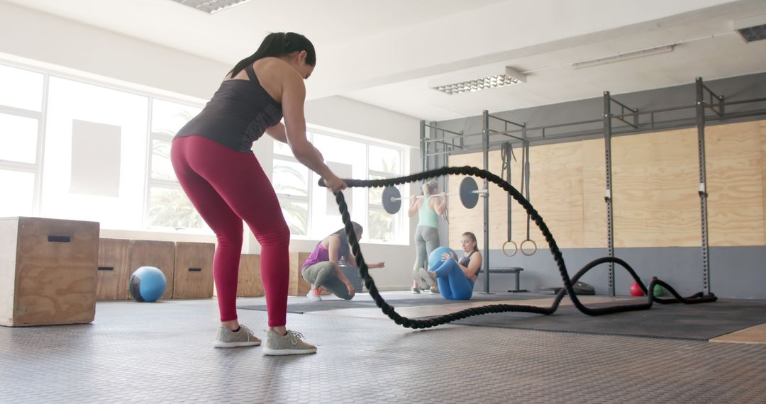 Focused Woman Training with Battle Ropes in Gym - Free Images, Stock Photos and Pictures on Pikwizard.com