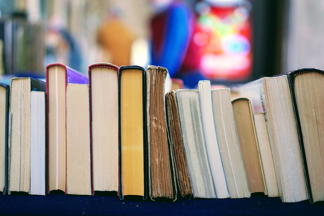 Row of Books on Blue Table Inside Bookstore