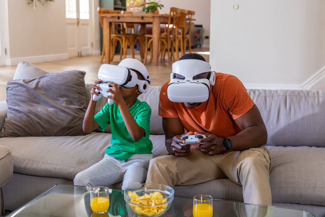 African American Father and Son Playing VR Games on Couch at Home for Family Bonding