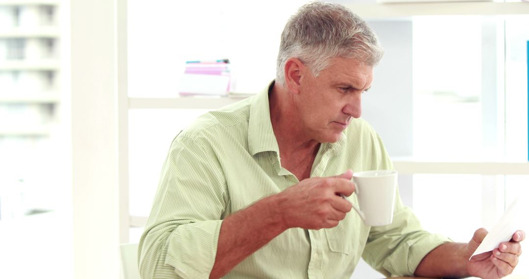 Senior Man Drinking Coffee and Using Tablet at Home - Free Images, Stock Photos and Pictures on Pikwizard.com