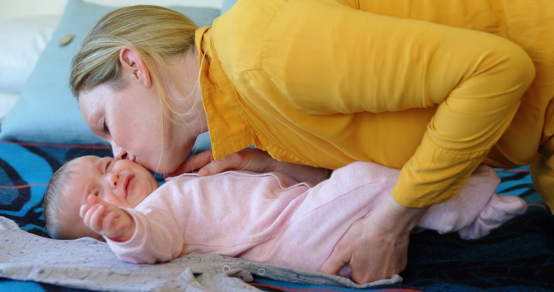 Caucasian woman comforts her crying baby at home - Free Images, Stock Photos and Pictures on Pikwizard.com