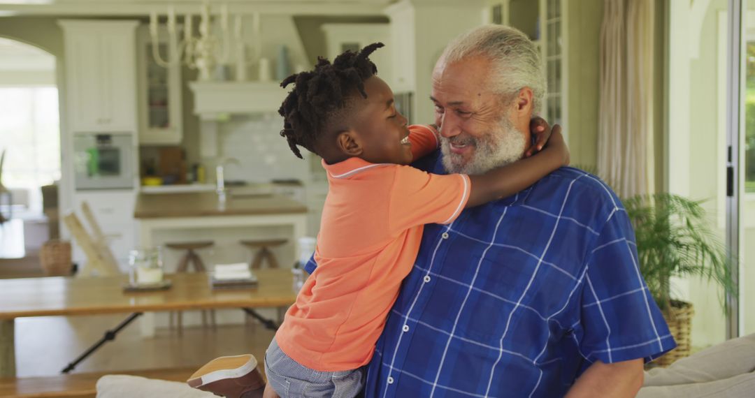 Grandfather and grandson hugging in cozy kitchen - Free Images, Stock Photos and Pictures on Pikwizard.com