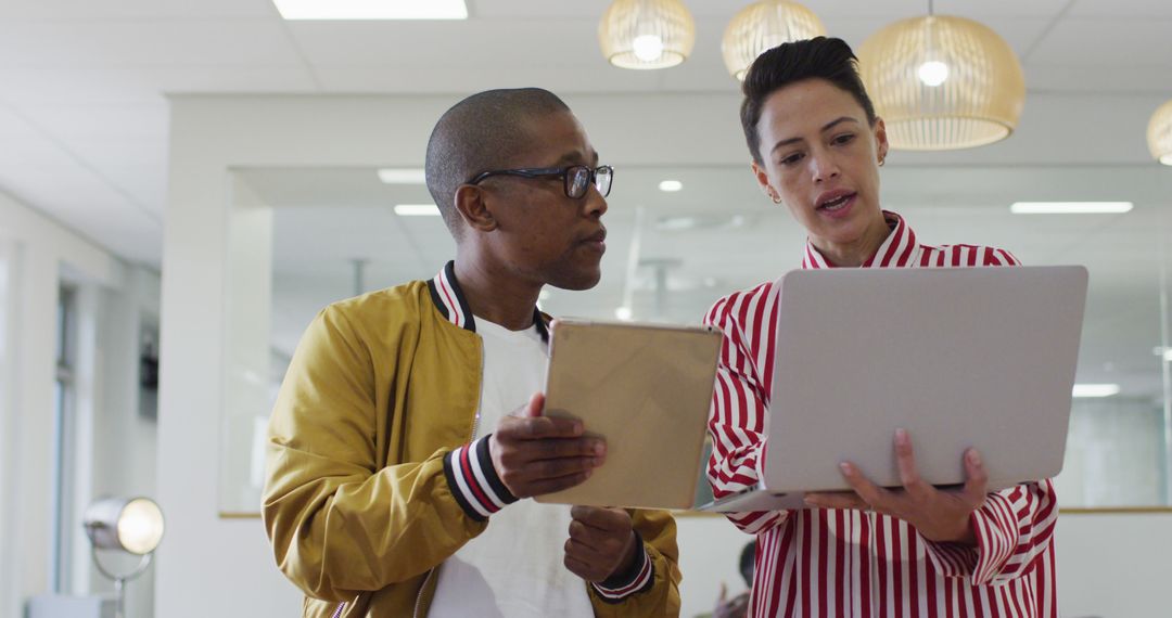 Diverse Colleagues Discussing Work in Modern Office Setting