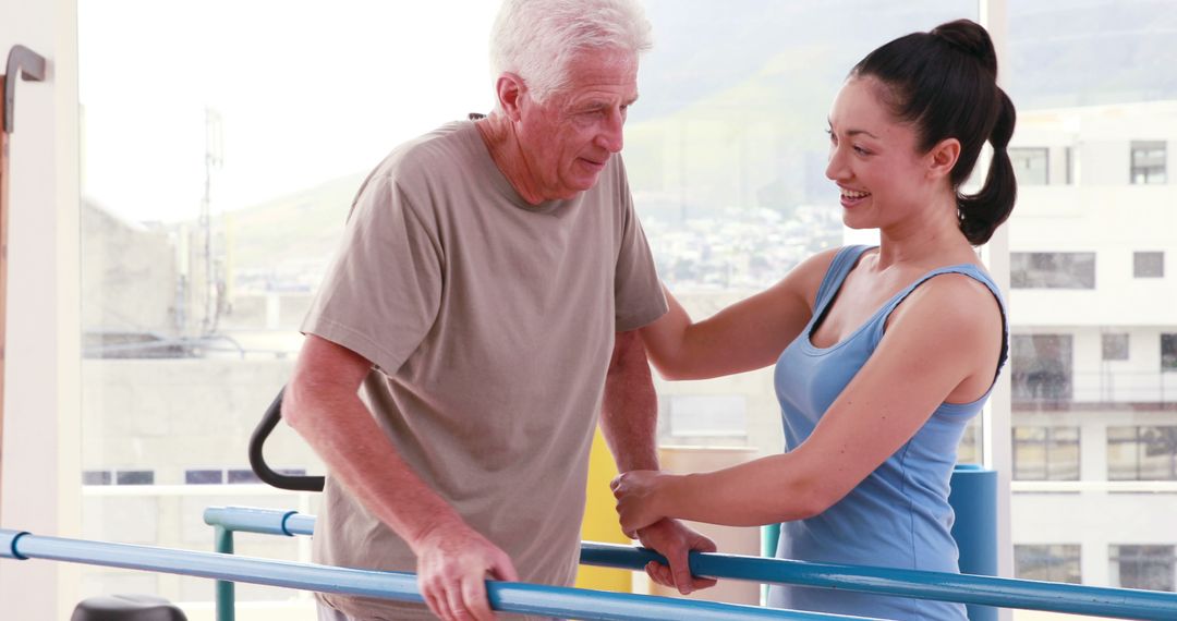 Elderly man exercising with physical therapist support in rehabilitation center - Free Images, Stock Photos and Pictures on Pikwizard.com