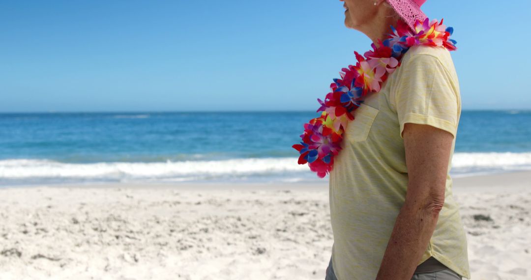 Senior Woman Enjoying Tropical Beach Vacation in Light Accessories - Free Images, Stock Photos and Pictures on Pikwizard.com