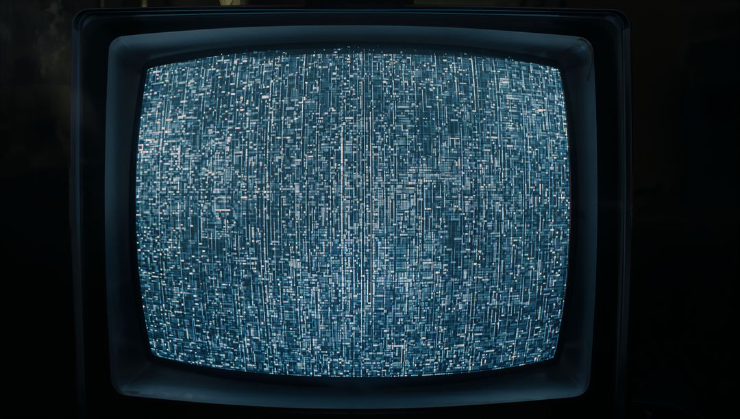 Vintage CRT Television Showing Blue Static Screen in Dim Light