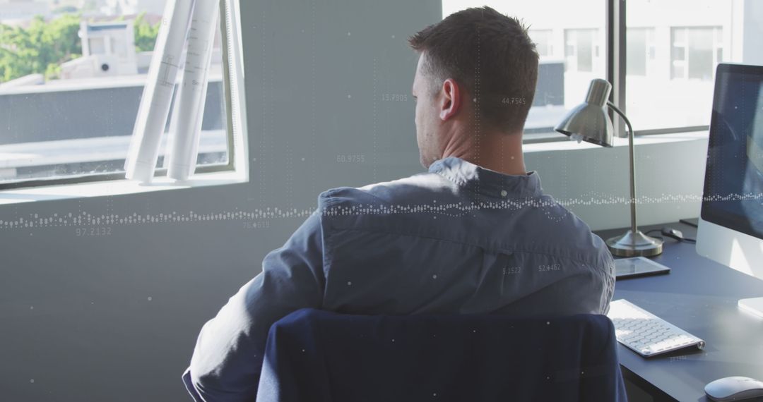 Businessman Contemplating at Desk with Data Overlay